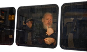 Assange is seen in a police van after he was arrested by British police.