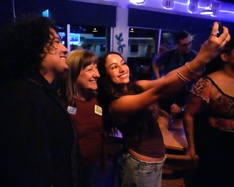 three people smile for a selfie