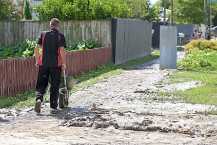 Residents in Taradale clean up silt on Wednesday from flood waters in Napier.