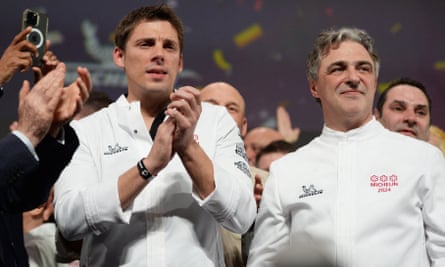 Fabien Ferré (left) and Jérôme Banctel celebrate on stage during the Michelin Guide for France 2024 awards