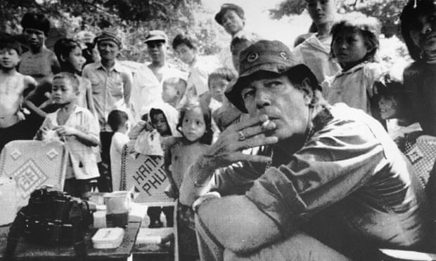 Tim Page surrounded by local children at a coffee stand in Chimpou, Cambodia, 1991.