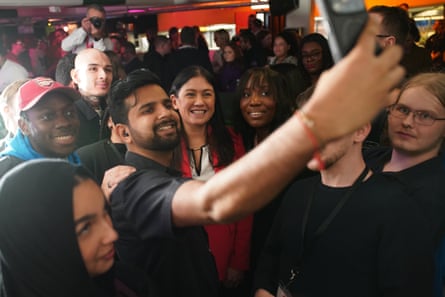 Group of people take a selfie.