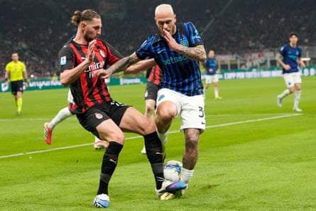 Federico Dimarco and Adrien Rabiot challenge for the ball during the Serie A match between Milan and Inter