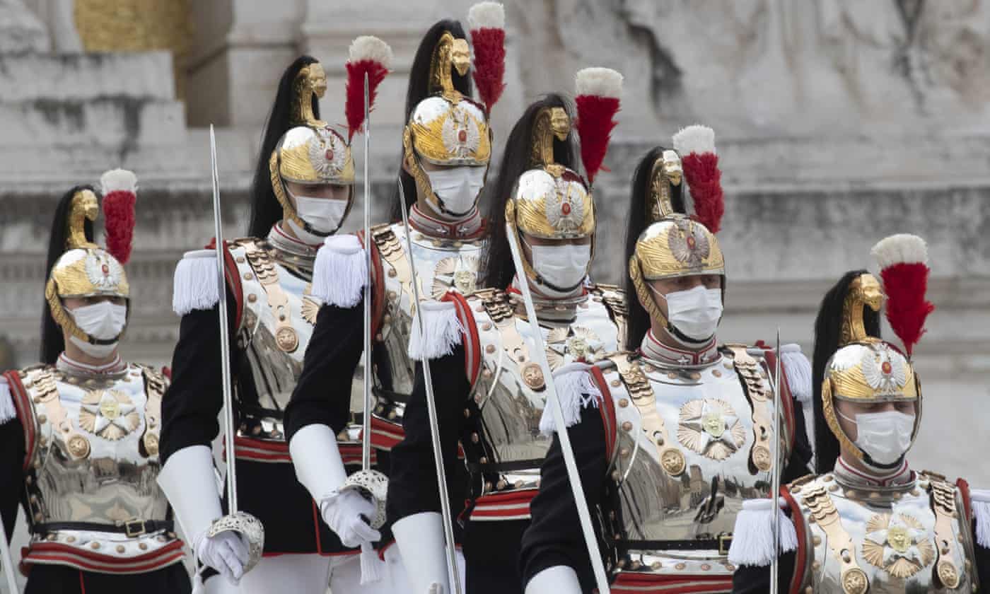 Courassier presidential guards wearing face masks to curb the spread of Covid-19 arrive at Rome’s Monument to the Unknown Soldier. Photograph: Alessandra Tarantino/AP