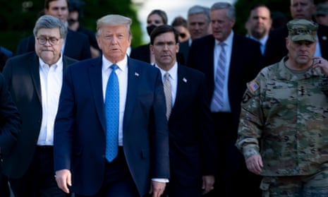 Donald Trump walks with aides including secretary of defense Mark Esper and chairman of the Joint Chiefs of Staff Mark Milley.