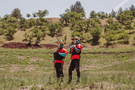 two people stand in a field