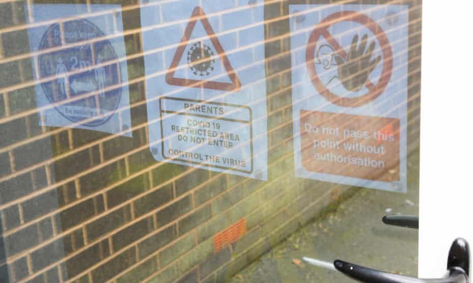 Signage giving Covid advice on a school door in Oldham