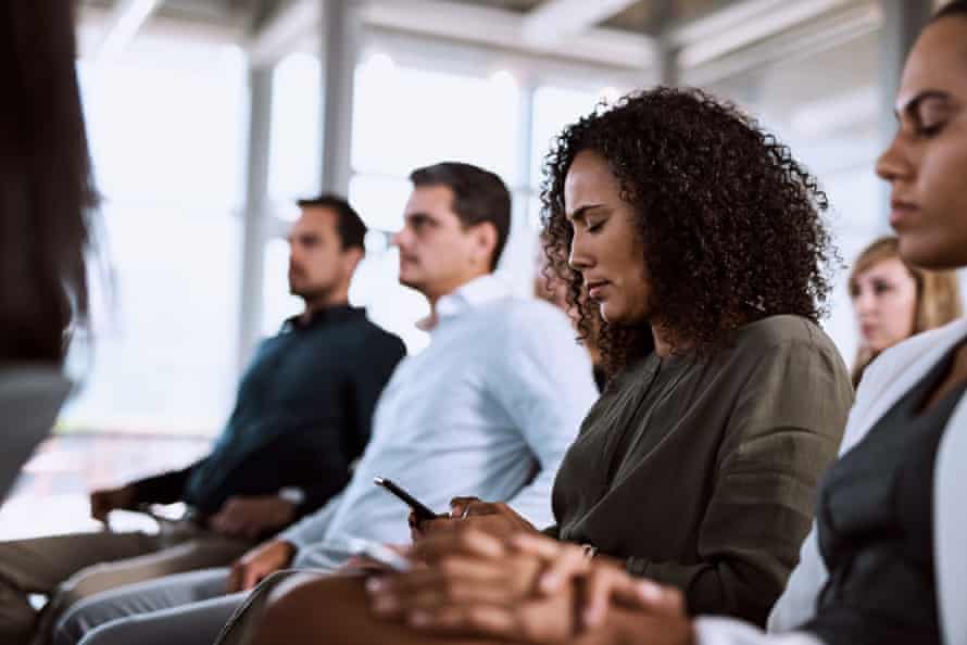 Making notes for follow upPosed by model Shot of a businesswoman using her mobile phone during a conference