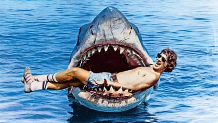 Steven Spielberg poses with the model shark