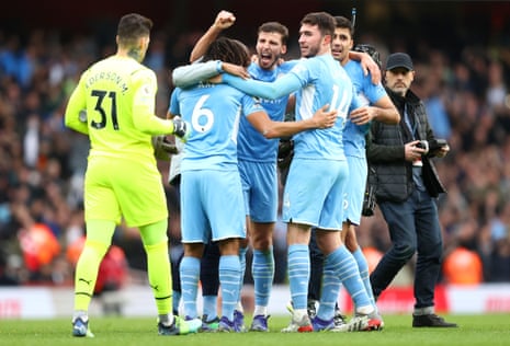 Manchester City players celebrate at full time.