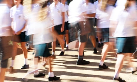 Large number of male and female students wearing neat uniforms 