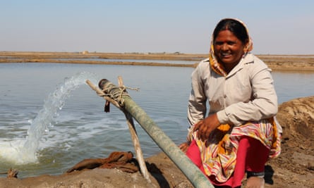 Salt farmer Kirti Ben beside her pumped brine pipe