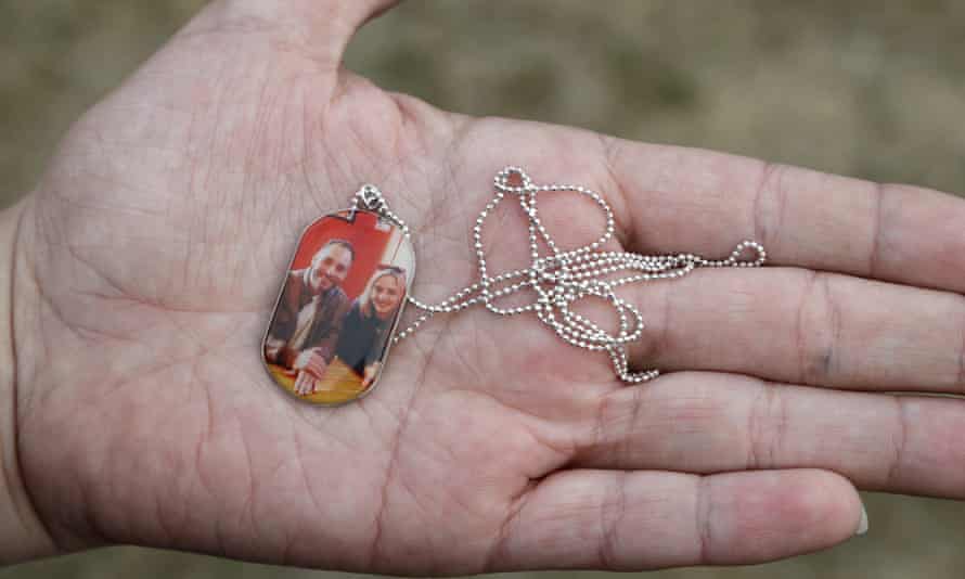 Aya Al-Umari, whose brother Hussein Al-Umari was killed in Al Noor mosque shooting, holds a pendant with a photo of herself and Hussein.