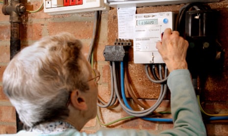 Older woman checks prepayment electric meter