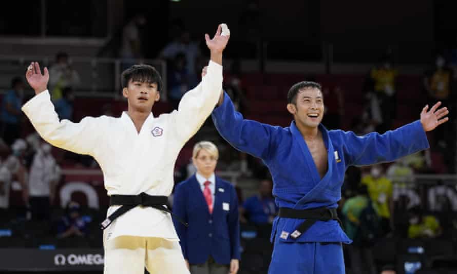 Japanâs Naohisa Takato, in blue, celebrates gold in the menâs under 60kg judo.