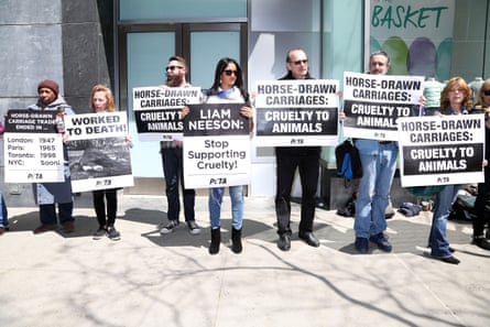 people hold signs outside