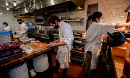 Chefs Brittany Ha, left, Liz Johnson, Will Aghajanian, and line cook Kristi Kutei, right, prep dishes before dinner service on 23 December 2021.
