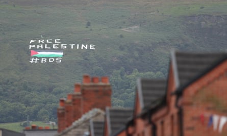 A protest message saying Free Palestine with chimney pots in foreground