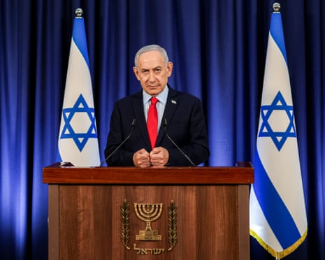 Benjamin Netanyahu stands at a podium flanked by two Israeli flags, at a press conference in Jerusalem