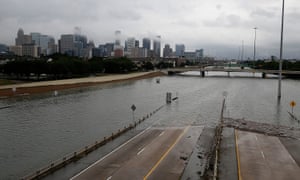 The downtown Houston skyline and flooded highway 288.