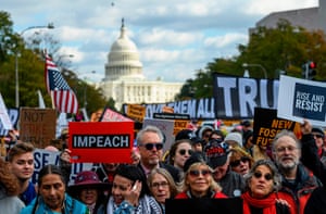Demostrators including Jane Fonda march past the Trump International hotel during a climate rally in Washington.
