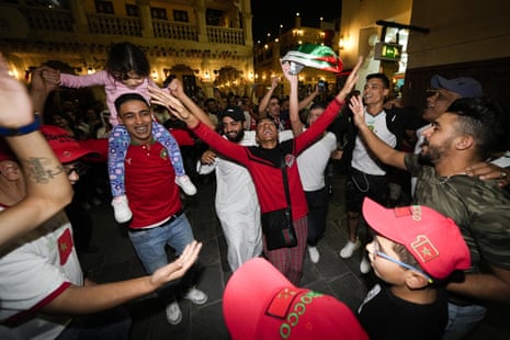 Moroccan fans dance at the Souq Waqif on Saturday night in Doha.