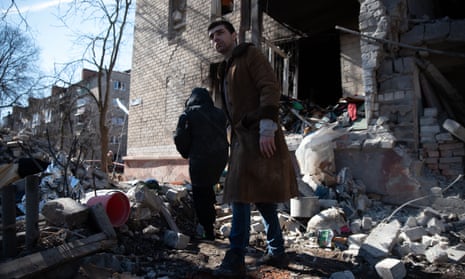 Kramatorsk residents clear debris from their apartment after the missile strike on Tuesday