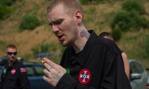 A white nationalist takes a break from marching in formation