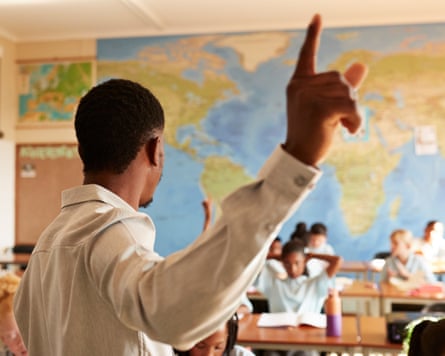 A teacher points to a map.