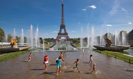 Children play in front of the Eiffel Tower, Paris.