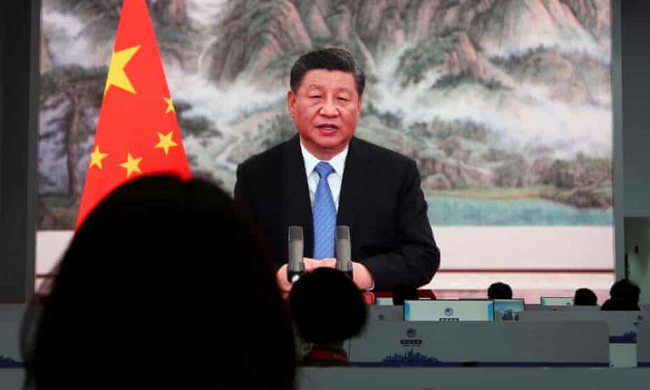 Xi Jinping speaking beside China's flag