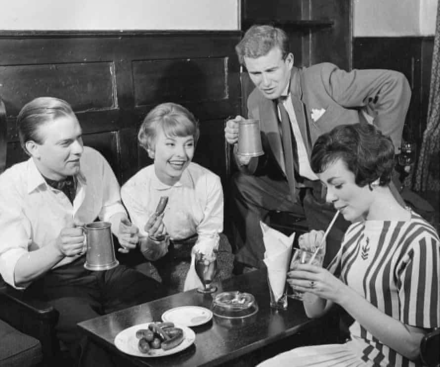 Pub-goers enjoying bar snacks at the Spaniards Inn, north London, in 1958.