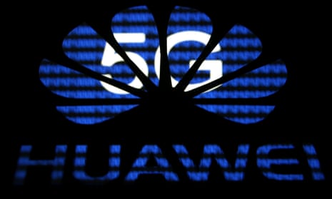 A 3D printed Huawei logo is seen in front of displayed 5G words