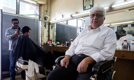 Iskander Hinn in his barber shop in Ramallah