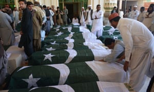 Pakistani mourners gather on Tuesday around the coffins of some of those killed in the attack in Quetta