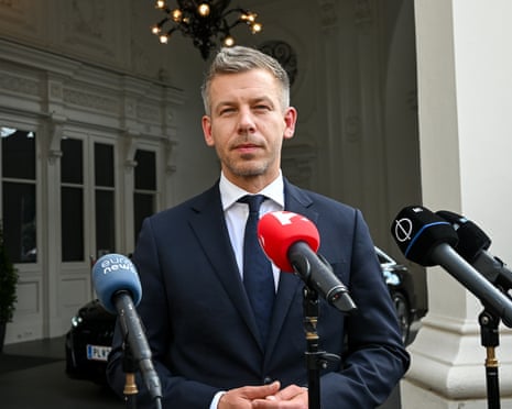 Péter Magyar speaks into media microphones
