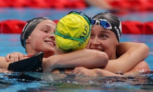 Netherlands’ gold medalist Chantalle Zijderveld (left) and silver medalist Lisa Kruger (right) and bronze medalist Keira Stephens of Australia embrace each other after competing in the women’s SB9 100m breaststroke final.