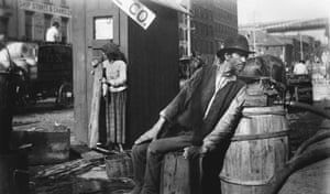 black and white photo of a man holding his neck out as he sits outside