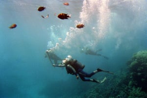 Wendy Craig-Duncan a Marine Biologist on the Great Barrier Reef, Australia, carries the Sydney Olympic torch underwater at Agincourt Reef, Great Barrier Reef, Queensland, Australia on 27 June 2000.