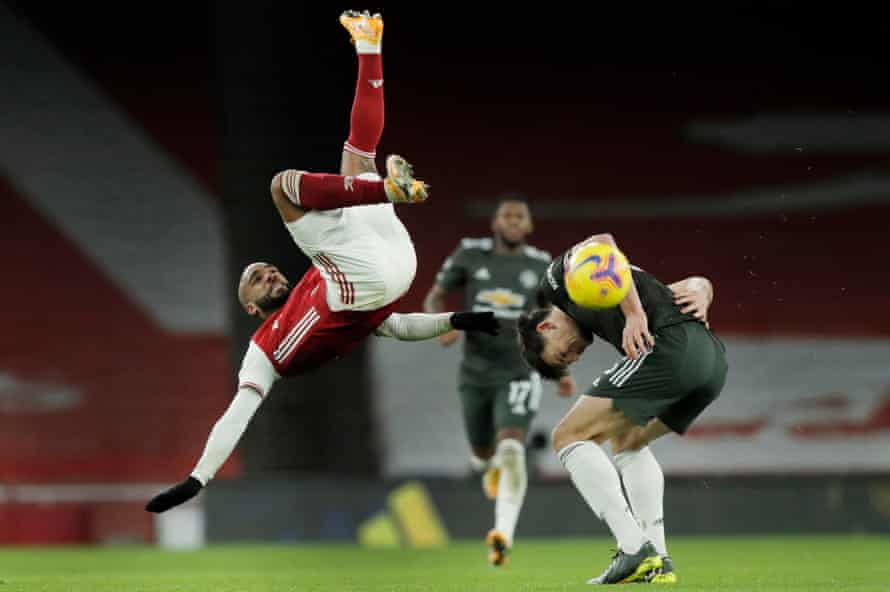 Alexandre Lacazette flies over the back of Harry Maguire during the Premier League match between Arsenal and Manchester United at the Emirates Stadium on 30 January 2021.