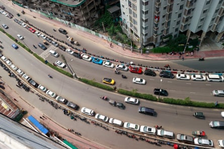 People in Dhaka, Bangladesh wait in a long queue as they rush to petrol pumps to refuel amid fears of a shortage in April.