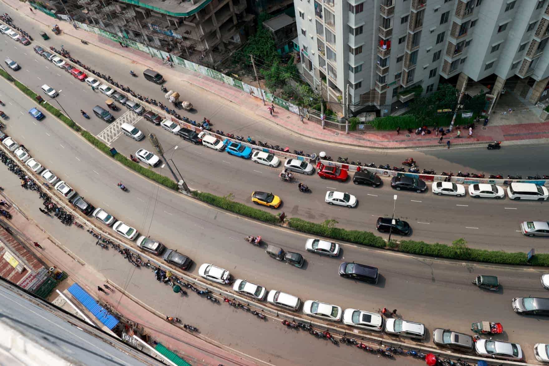 People in Dhaka, Bangladesh wait in a long queue as they rush to petrol pumps to refuel amid fears of a shortage in April.