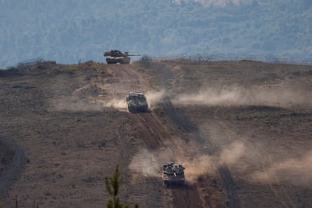 Tanks driving up a hill.
