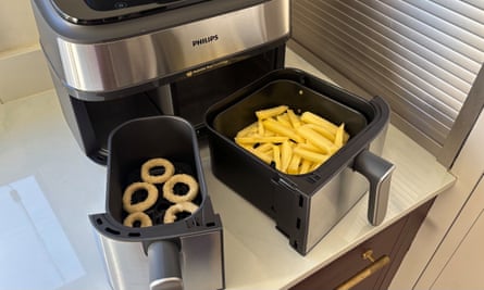An air fryer with chips and onion rings