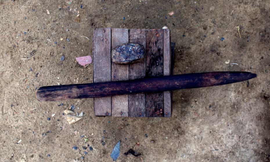 A stone and stick used to iron breasts