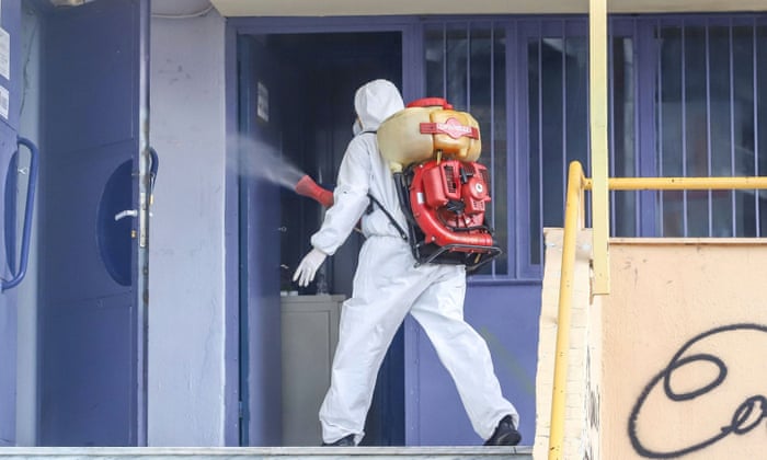 A man in protective suit disinfects a school facility where a child was diagnosed with coronavirus, in ThessalonikiA man in a protective suit disinfects a school facility where a child was diagnosed with coronavirus, in Thessaloniki, Greece, February 27, 2020.