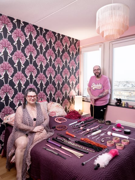 Bustie, 49, burlesque performer, and Tony, 60, Amsterdam, Netherlands photographed in a very pink bedroom with lots of sex toys laid out on their bed