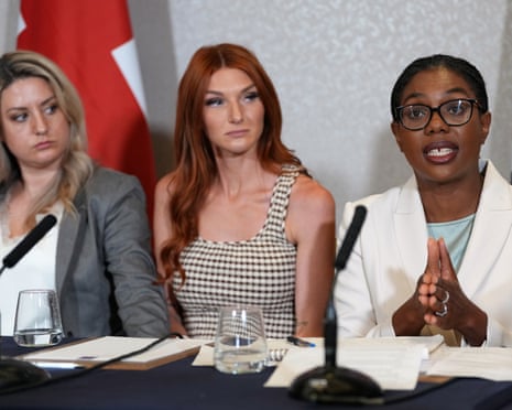 Victims of crime Kayleigh Corbin, from left, and Jade Belgrove listen to Kemi Badenoch as they attend a press conference together