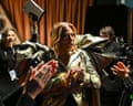 Queen Latifah backstage at the Oscars, smiling and clapping