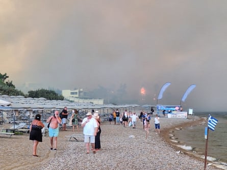 People on Kiotari beach during the wildfires